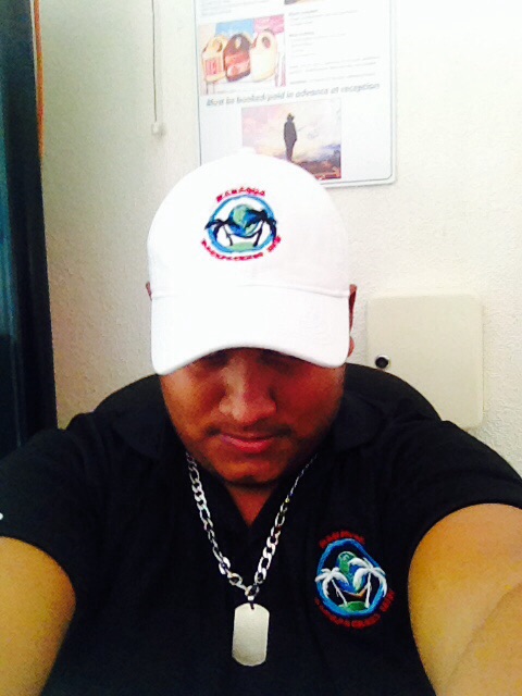 Team member wearing the original Managua Backpackers Inn uniform and logo.
