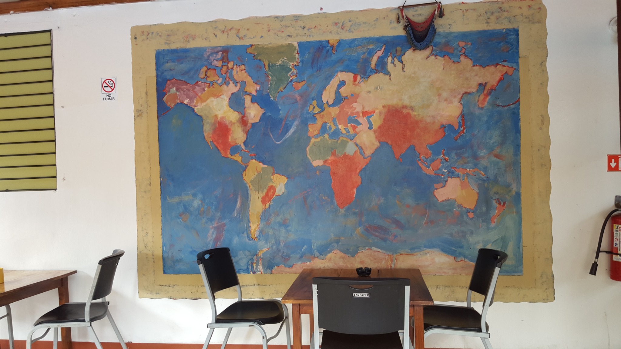 Hand-painted world map in a communal area of Managua Backpackers Inn.
