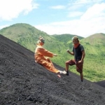 atop Cerro Negro volcano in Nicaragua, looking over the black volcanic landscape