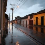 “Colonial Granada street glistens after a warm afternoon rain in July.”
